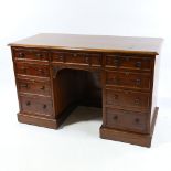 A Victorian mahogany pedestal desk, with 9 drawers, relief carved apron and panelled back alcove,