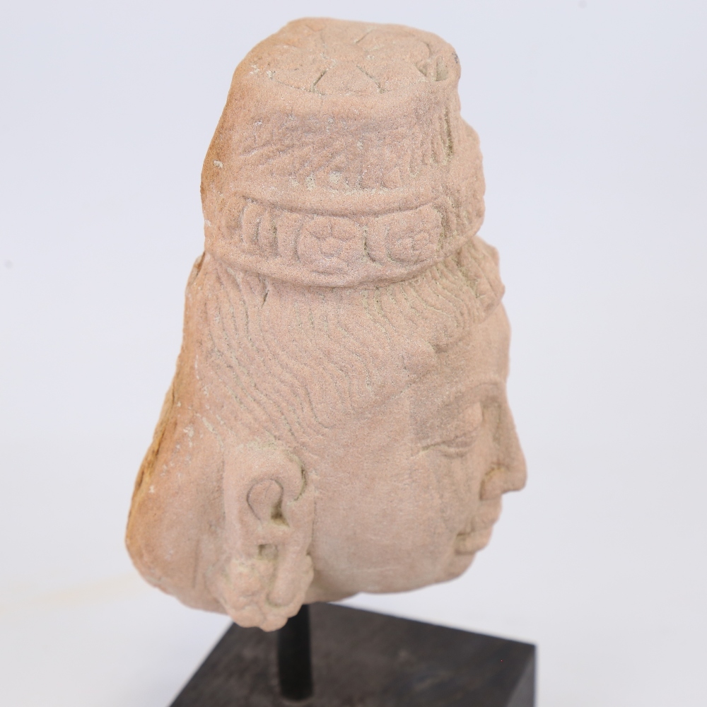 An Indian carved red stone head of a goddess, modern block plinth, overall height 23cm Probably a - Image 4 of 4