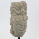 An Indian carved greenstone head of a man, modern block plinth, overall height 24.5cm Probably a