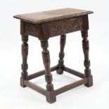 An Antique oak joint stool, with carved frieze and baluster supports, height 55cm