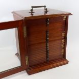 A Victorian mahogany microscope slide cabinet, brass carrying handle with glazed panelled door