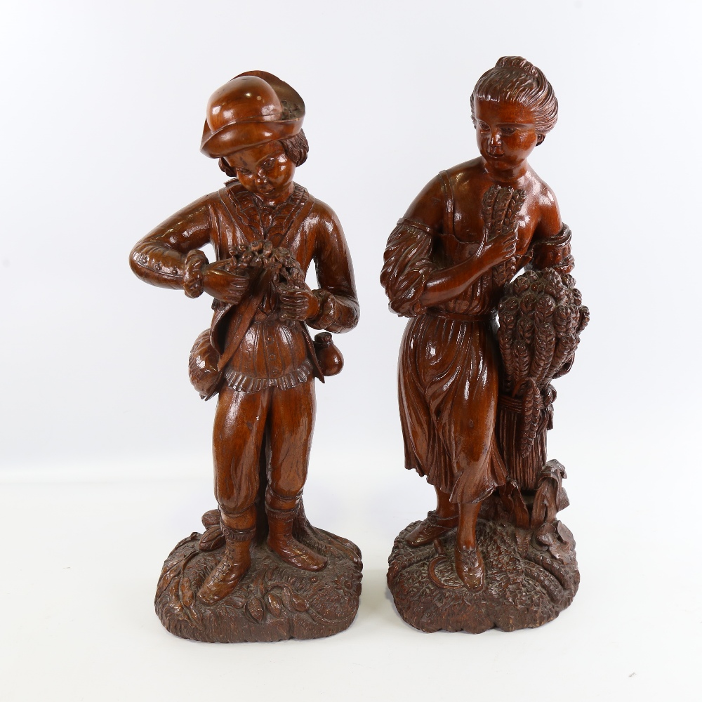 A pair of 19th century carved and stained wood standing harvest figures, height 48cm Both in good