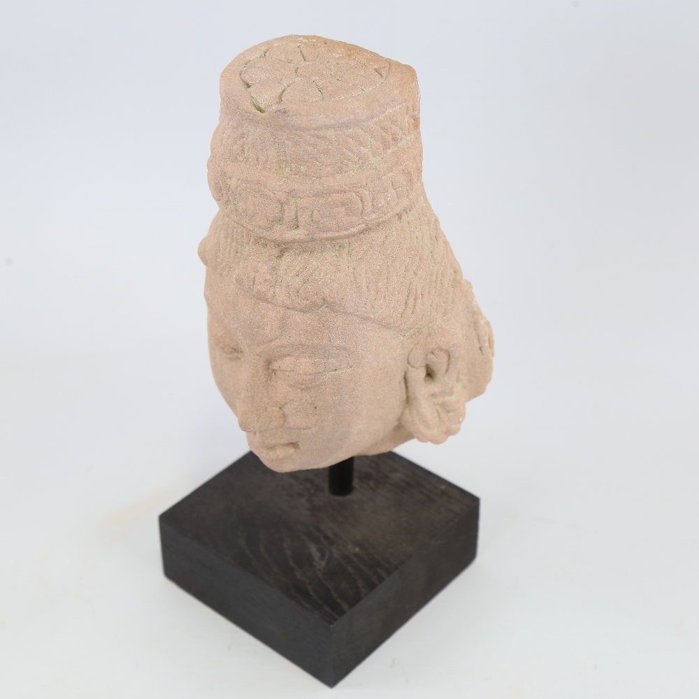 An Indian carved red stone head of a goddess, modern block plinth, overall height 23cm Probably a - Image 2 of 4