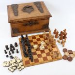 A Victorian walnut games compendium, the case having relief embossed copper strapwork mounts with