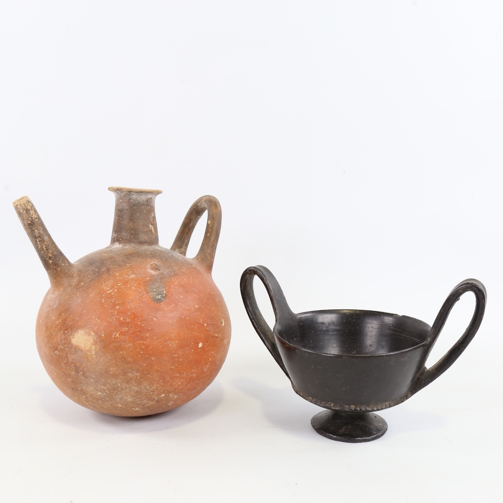 An Ancient terracotta globular redware flagon, height 18cm, and an Ancient Greek blackware 2-handled