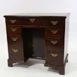 A George III mahogany kneehole writing desk of small size, with alcove cupboard and drawers, 81cm
