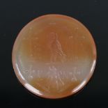A circular natural agate seal, intaglio carved armorial crest, diameter 3cm Good condition