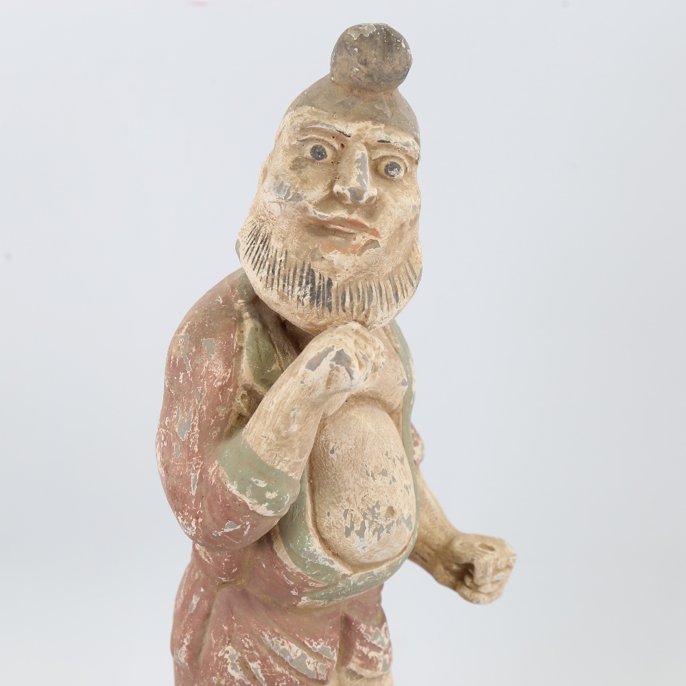 An Indian/Chinese painted terracotta standing figure wearing a turban, on wood plinth, height 41cm