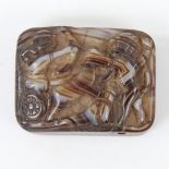 A Roman banded agate plaque, with relief carved scene depicting a battle scene with a bow-man riding