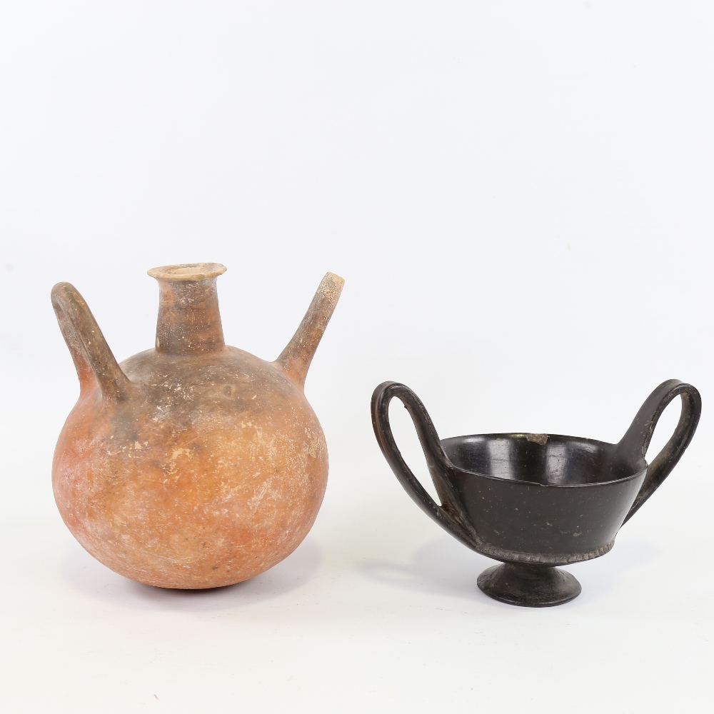 An Ancient terracotta globular redware flagon, height 18cm, and an Ancient Greek blackware 2-handled - Image 2 of 4