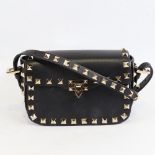 VALENTINO - a small black leather and steel studded handbag with strap, length 15.5cm, with