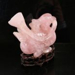 A Chinese carved rose quartz bird on hardwood stand, overall height 16cm Large chip just above the