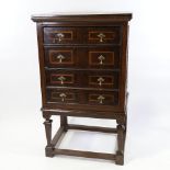 A 17th/18th century oak and walnut chest on stand, with linenfold panelled sides and inlaid drawer