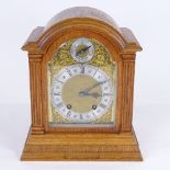 A late 19th/early 20th century German light oak-cased dome-top mantel clock, by Lenzkirch,