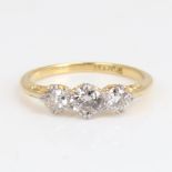 An early 20th century 18ct gold 3-stone diamond ring, set with round brilliant-cut diamonds, total