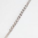 A late 20th century 18ct white gold diamond trefoil bracelet, set with round brilliant-cut diamonds,