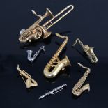 A group of good quality costume jewellery woodwind instrument brooches, including Future Primitive