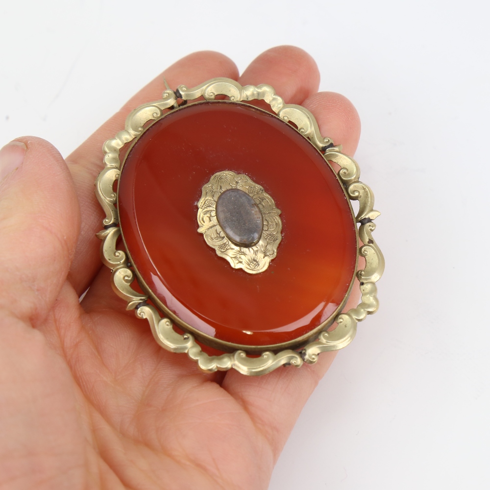 A large Victorian oval mourning brooch, unmarked yellow metal settings with red banded agate and - Image 5 of 5