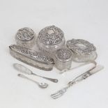 A group of silver-topped dressing table toilet jars, silver sugar tongs, butter knife, mustard spoon