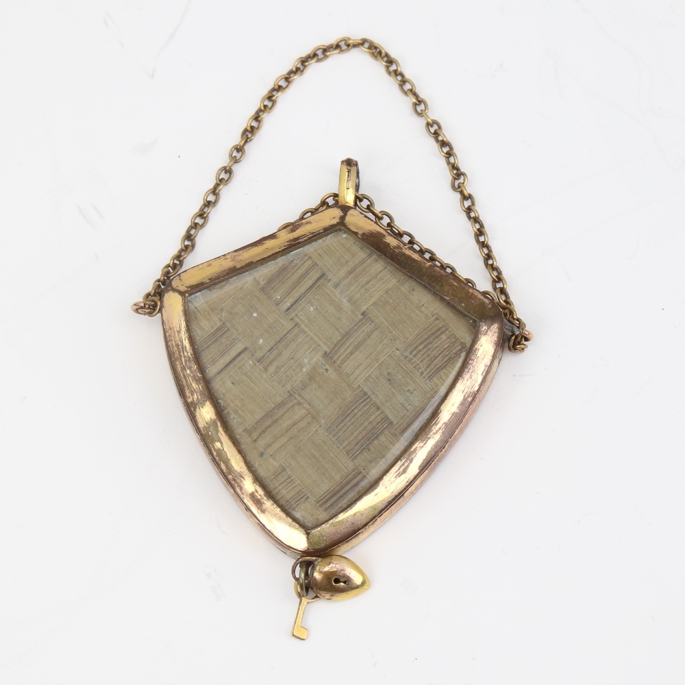 A Victorian unmarked yellow metal mourning pendant, shield form with bevel-glass panels and - Image 2 of 5