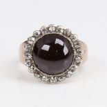An Antique unmarked gold cabochon garnet and diamond cluster ring, set with round cabochon foil-back