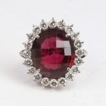 A large 18ct white gold faceted pink rhodolite garnet and diamond cluster ring, total diamond