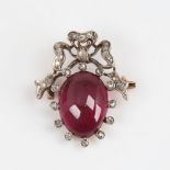 A Victorian unmarked gold garnet and diamond ribbon brooch/pendant, set with oval cabochon garnet