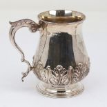 An Edwardian silver half pint tankard mug, cylindrical baluster form with relief embossed acanthus