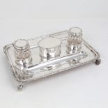 A George V silver deskstand, rectangular form with pen trays, 2 silver-mounted glass inkwells and