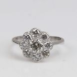 An unmarked white gold diamond cluster flowerhead ring, set with modern round brilliant-cut