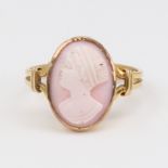 An unmarked gold relief carved pink coral cameo ring, depicting female profile, setting height 16mm,