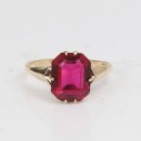 A late 20th century 9ct gold red stone ring, set with emerald-cut red stone, setting height 11mm,