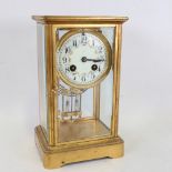 An early 20th century French brass-cased 4-glass 8-day mantel clock, floral white enamel dial with