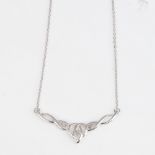 A modern 9ct white gold diamond pendant necklace, openwork stylised settings, pendant width 34mm,