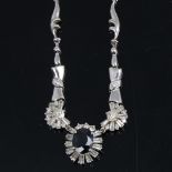 A modern 18ct white gold sapphire and diamond cluster necklace, set with 2.85ct oval-cut sapphire,