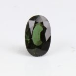 A 6.73ct unmounted oval mixed-cut green tourmaline, dimensions: 14.66mm x 9.27mm x 7.08mm, 1.36g