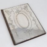 An Edwardian silver-fronted leather desktop notecase holder, engraved Adams style floral swag