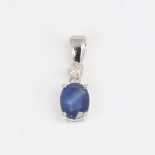 A modern 14ct white gold sapphire and diamond drop pendant, set with oval mixed-cut sapphire and