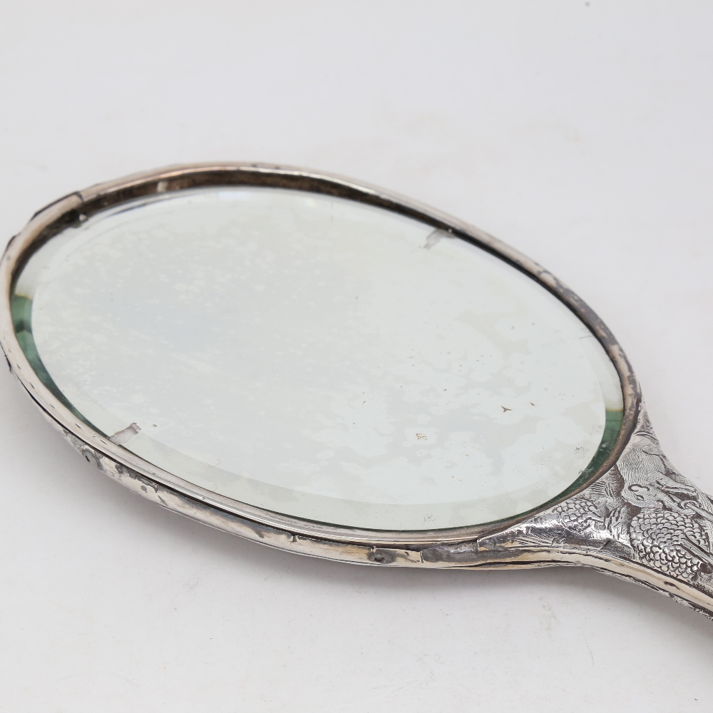 An unmarked Indian silver dressing table hand mirror, allover relief embossed animal and jungle - Image 4 of 5