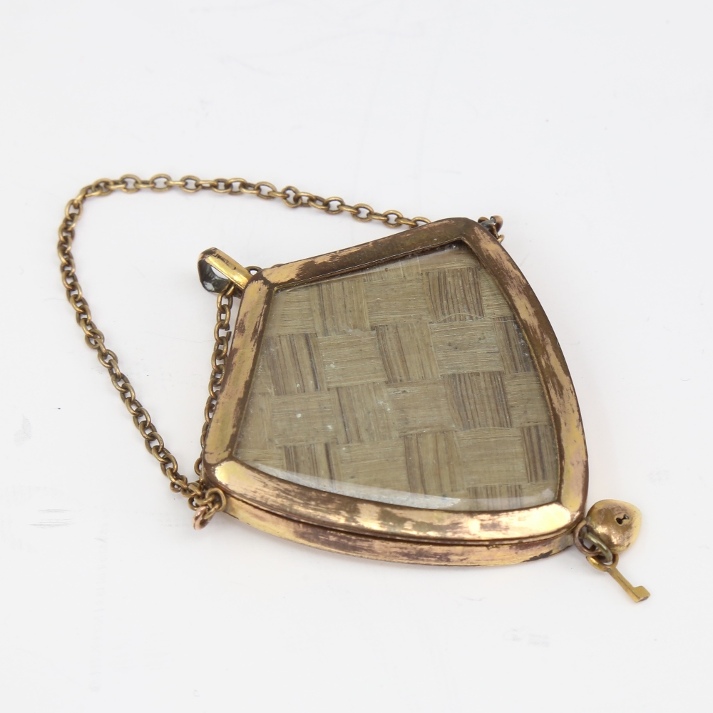 A Victorian unmarked yellow metal mourning pendant, shield form with bevel-glass panels and - Image 3 of 5