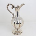 A William IV silver baluster Claret/hot water jug, lobed form with allover foliate engraved