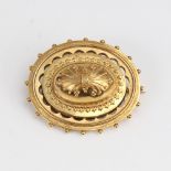 A Victorian unmarked gold bombe Etruscan style memorial brooch, openwork settings with bead edge and