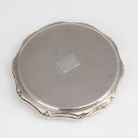 An Elizabeth II circular silver compact, allover engine turned decoration with scalloped rim and