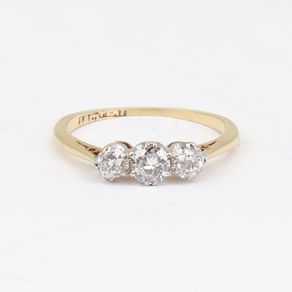 An early 20th century 18ct gold 3-stone diamond ring, set with round brilliant and old-cut diamonds,