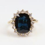 A late 20th century 18ct gold sapphire and white zircon cluster ring, set with oval mixed-cut