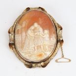 A large Victorian relief carved shell cameo brooch, depicting family in a courtyard, in unmarked