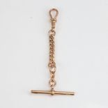 An early 20th century 9ct rose gold short curb link Albert chain, with dog clip and T-bar, maker's
