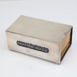 A large George V rectangular silver desktop matchbox holder, plain form on bun feet, maker's marks F