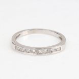 A modern unmarked white gold diamond half eternity ring, set with modern round brilliant-cut