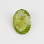 A 5.07ct unmounted oval mixed-cut peridot, dimensions: 14.70mm x 10.88mm x 4.05mm, 1.01g, with IDT